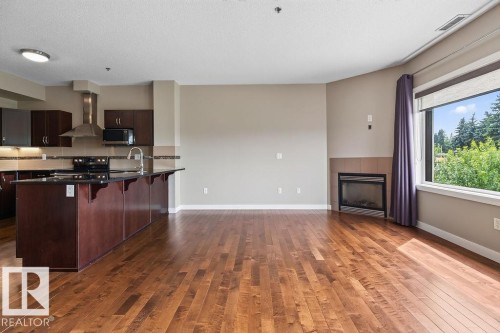 #303 35 Sturgeon Rd, St. Albert, AB - Indoor Photo Showing Kitchen With Fireplace