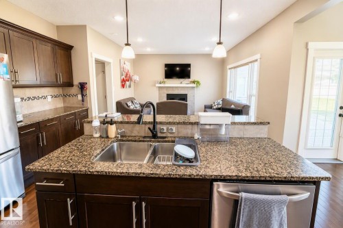 711 57 St Sw, Edmonton, AB - Indoor Photo Showing Kitchen With Fireplace With Double Sink With Upgraded Kitchen