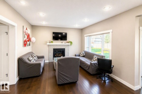 711 57 St Sw, Edmonton, AB - Indoor Photo Showing Living Room With Fireplace