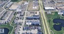 Aerial perspective showcasing the subject property's proximity to a superstore, Movati Gym, Shoppers Drug Mart, and Sobey's - 711 57 St Sw, Edmonton, AB  -  