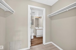 White hanging rods, light-toned walls, and wood-finish flooring - 