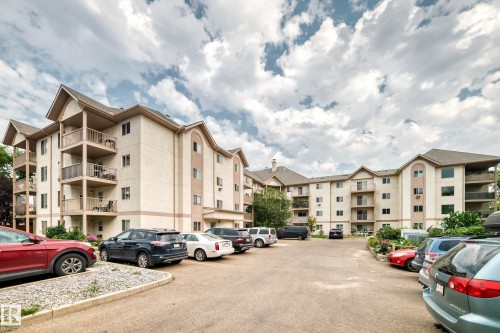 Multi-story building featuring balconies, multiple windows, and exterior stucco finishes - #204 11218 80 St Nw, Edmonton, AB - Outdoor With Balcony With Facade