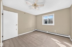 Wood-finish flooring, neutral wall tones, ceiling fan, and baseboard heat - 