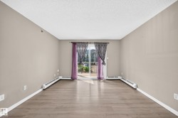 Wood-finish flooring, neutral wall tones, and a sliding glass door - 