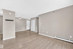 Wood-finish flooring, neutral wall tones, baseboard heating, ceiling fan with integrated lighting, and bi-fold closet doors - 