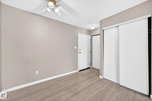 Wood-finish flooring with neutral wall tones - #204 11218 80 St Nw, Edmonton, AB - Indoor Photo Showing Other Room