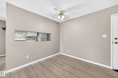 Wood-finish flooring with neutral wall tones - #204 11218 80 St Nw, Edmonton, AB - Indoor Photo Showing Other Room