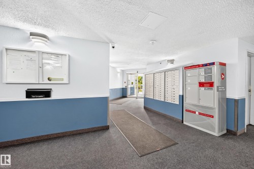 Mailbox system, bulletin board, and textured ceilings - #204 11218 80 St Nw, Edmonton, AB - Indoor Photo Showing Other Room