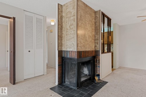 164 Surrey Gardens Nw, Edmonton, AB - Indoor Photo Showing Other Room With Fireplace