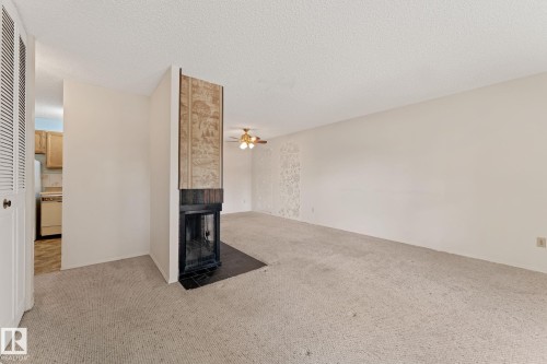 164 Surrey Gardens Nw, Edmonton, AB - Indoor Photo Showing Other Room With Fireplace