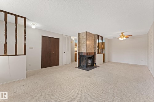 164 Surrey Gardens Nw, Edmonton, AB - Indoor Photo Showing Other Room With Fireplace