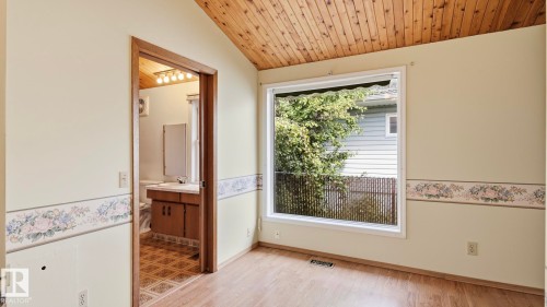Wood-finish vaulted ceiling, large window, wood-finish flooring, and a clear doorway - 8408 176 Street Nw, Edmonton, AB - Indoor Photo Showing Other Room