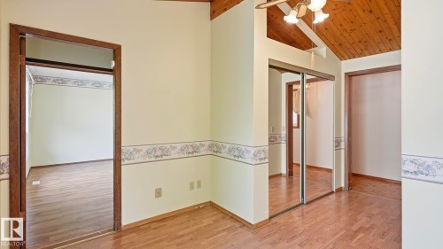 Vaulted wood-paneled ceiling, wood-finish flooring, and mirrored closet doors - 8408 176 Street Nw, Edmonton, AB - Indoor Photo Showing Other Room