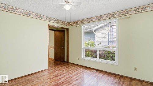 Wood-finish flooring with light-colored walls - 8408 176 Street Nw, Edmonton, AB - Indoor Photo Showing Other Room