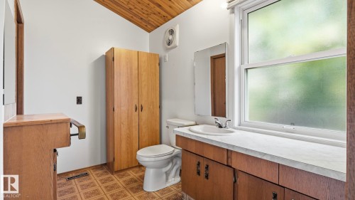 White walls with an angled wood-paneled ceiling - 8408 176 Street Nw, Edmonton, AB - Indoor Photo Showing Bathroom