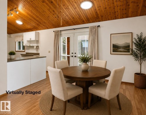 Wood-finish flooring, white walls, and a vaulted wood-paneled ceiling create an inviting atmosphere - 8408 176 Street Nw, Edmonton, AB - Indoor Photo Showing Dining Room