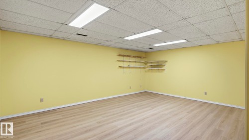 Recessed ceiling with integrated lighting, light wood-finish flooring, and built-in shelving - 8408 176 Street Nw, Edmonton, AB - Indoor