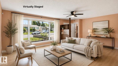 Spacious living area featuring large picture windows, wood-finish flooring, and a ceiling fan - 8408 176 Street Nw, Edmonton, AB - Indoor Photo Showing Living Room
