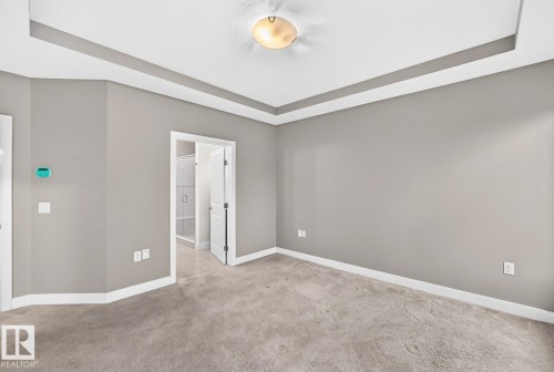 Tray ceiling with recessed lighting - #57 18343 Lessard Rd Nw, Edmonton, AB - Indoor Photo Showing Other Room
