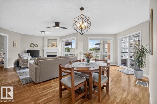 #300 7839 96 St Nw, Edmonton, AB - Indoor Photo Showing Dining Room With Fireplace