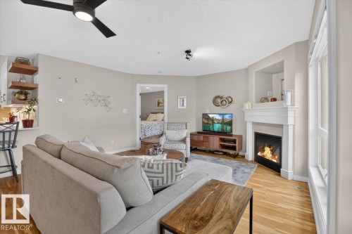 #300 7839 96 St Nw, Edmonton, AB - Indoor Photo Showing Living Room With Fireplace