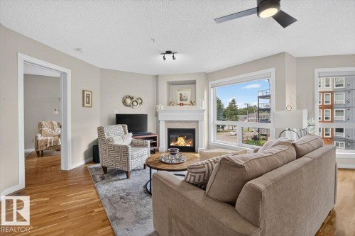 #300 7839 96 St Nw, Edmonton, AB - Indoor Photo Showing Living Room With Fireplace