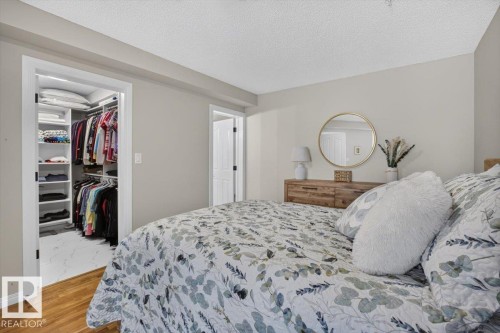 Note the walk in closet...both bedroom closets were done by California Closets - #300 7839 96 St Nw, Edmonton, AB - Indoor Photo Showing Bedroom