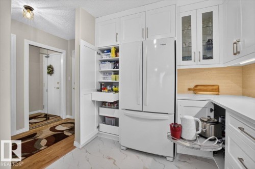 to show you a couple of the wonderful built ins this kitchen offers - #300 7839 96 St Nw, Edmonton, AB - Indoor Photo Showing Other Room
