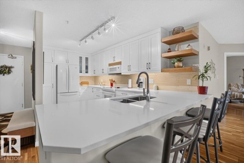 Quartz counters - #300 7839 96 St Nw, Edmonton, AB - Indoor Photo Showing Kitchen With Double Sink