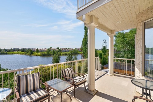 Spacious concrete balcony with a metal railing, supported by two white columns - 13527 158 Avenue Nw, Edmonton, AB - Outdoor With Body Of Water With Deck Patio Veranda With Exterior