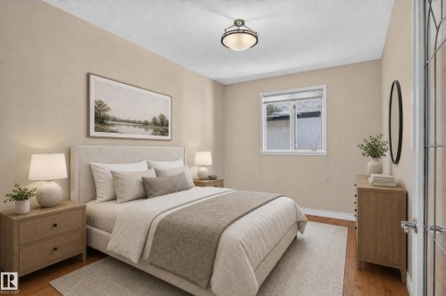 Hardwood flooring, light neutral wall color, window with white trim, ceiling-mounted light fixture, and a door with glass panels - 13527 158 Avenue Nw, Edmonton, AB - Indoor Photo Showing Bedroom