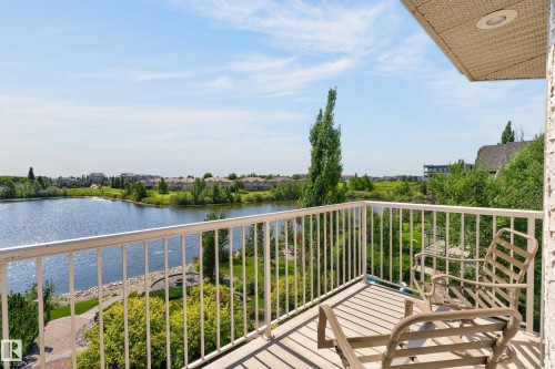 Balcony with white metal railing and a textured overhead soffit - 13527 158 Avenue Nw, Edmonton, AB - Outdoor With Body Of Water With View