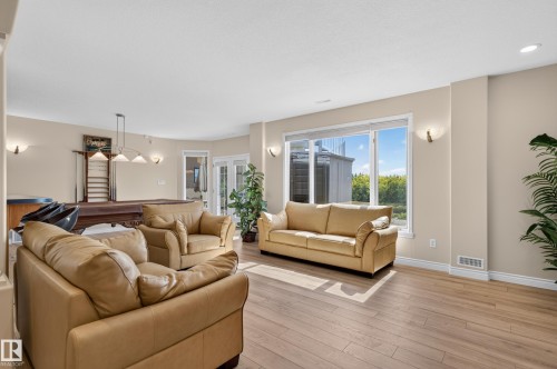 Recessed lighting, wood-finish flooring, and white trim - 13527 158 Avenue Nw, Edmonton, AB - Indoor Photo Showing Living Room