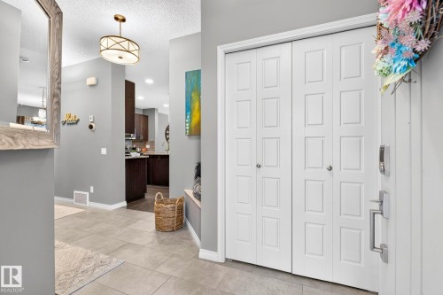 Entryway featuring neutral wall colors, recessed lighting, tile flooring, and a decorative semi-flush mount ceiling fixture - 16512 140 Street Nw, Edmonton, AB - Indoor Photo Showing Other Room