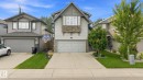 Contemporary exterior with mixed siding and stone accents, dual garage doors, concrete driveway, and landscaped front yard - 16512 140 Street Nw, Edmonton, AB  - Outdoor With Facade 