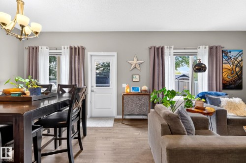 Wood-finish flooring, neutral wall tones, recessed lighting, and ample natural light from multiple windows - 16512 140 Street Nw, Edmonton, AB - Indoor Photo Showing Dining Room