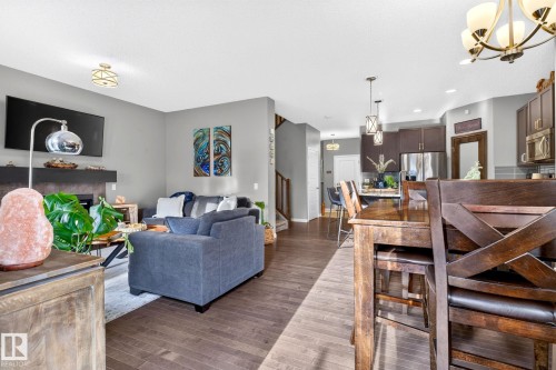 Open-concept living area with dark wood-finish flooring - 16512 140 Street Nw, Edmonton, AB - Indoor