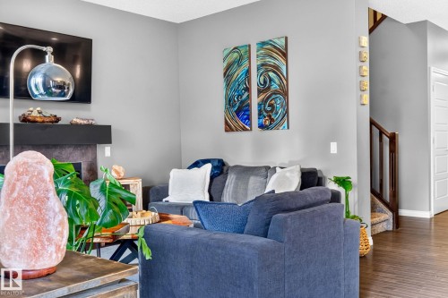 Fireplace with a dark stone surround and a built-in mantel - 16512 140 Street Nw, Edmonton, AB - Indoor Photo Showing Living Room