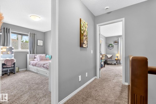 Carpeted hallway with painted walls and white trim - 16512 140 Street Nw, Edmonton, AB - Indoor
