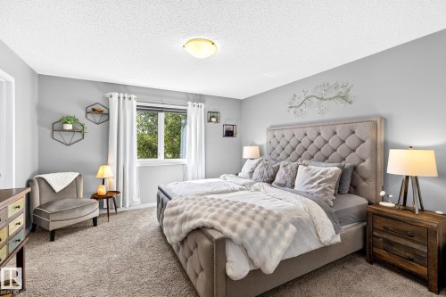 Plush wall-to-wall carpeting, window with natural light, neutral wall colors, and a ceiling-mounted light fixture - 16512 140 Street Nw, Edmonton, AB - Indoor Photo Showing Bedroom