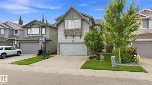 Contemporary facade featuring horizontal siding and stone accents - 16512 140 Street Nw, Edmonton, AB - Outdoor With Facade