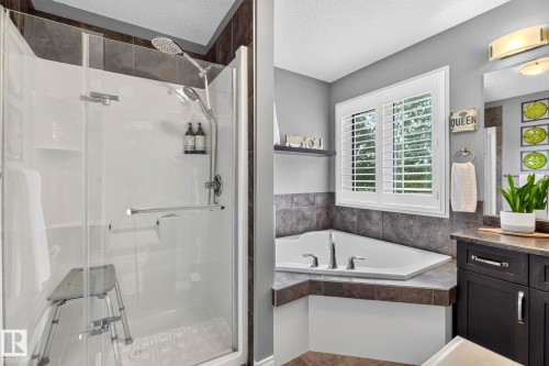 Walk-in shower with clear glass enclosure and chrome fixtures - 16512 140 Street Nw, Edmonton, AB - Indoor Photo Showing Bathroom