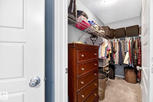 Walk-in closet with wire shelving and carpet flooring - 16512 140 Street Nw, Edmonton, AB - Indoor With Storage