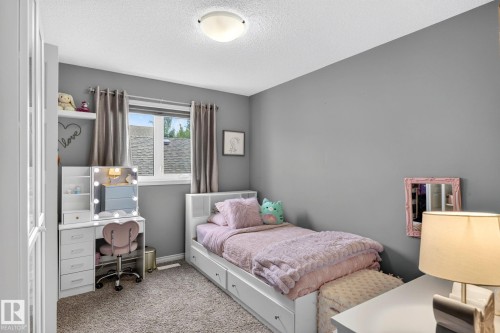 Recessed window with gray drapes, gray walls, light-colored carpeting, and a flush-mount ceiling light - 16512 140 Street Nw, Edmonton, AB - Indoor Photo Showing Bedroom