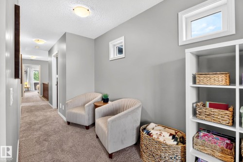 Built-in shelving, carpeted flooring, and neutral wall paint - 16512 140 Street Nw, Edmonton, AB - Indoor Photo Showing Other Room