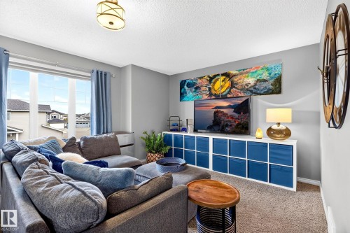 Recessed lighting, large window with ample natural light, built-in storage unit, and neutral wall tones - 16512 140 Street Nw, Edmonton, AB - Indoor Photo Showing Living Room
