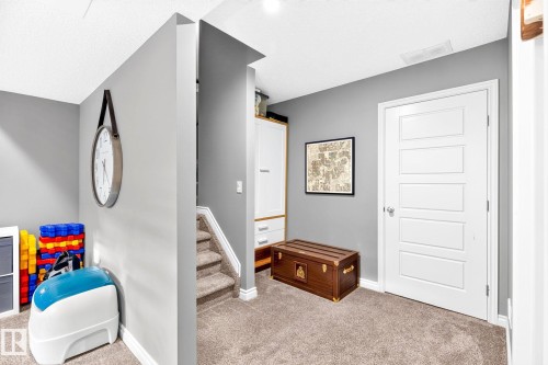 Carpeted flooring, white trim, recessed lighting, white paneled door, built-in cabinetry with wood-finish accents - 16512 140 Street Nw, Edmonton, AB - Indoor
