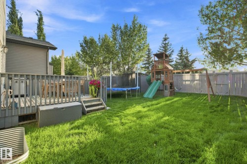 Expansive green lawn with a wooden privacy fence - 16512 140 Street Nw, Edmonton, AB - Outdoor With Deck Patio Veranda With Backyard