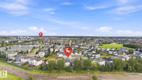Expansive residential area with numerous detached properties, green spaces, and a clear blue sky - 16512 140 Street Nw, Edmonton, AB - Outdoor With View