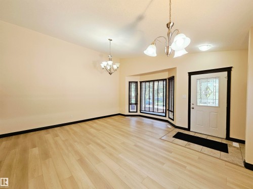 Light wood-finish flooring with a tiled entryway - 11625 88 Street Nw, Edmonton, AB 